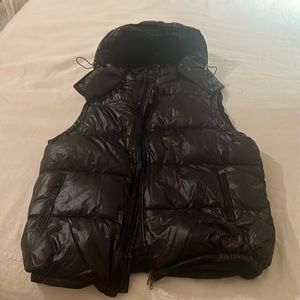 Black puffer vest, never worn, and in great condition